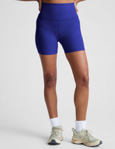 model is wearing blue high-waisted 5" inseam biker shorts.